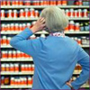 Photo: Woman standing in front of a display of dietary supplements