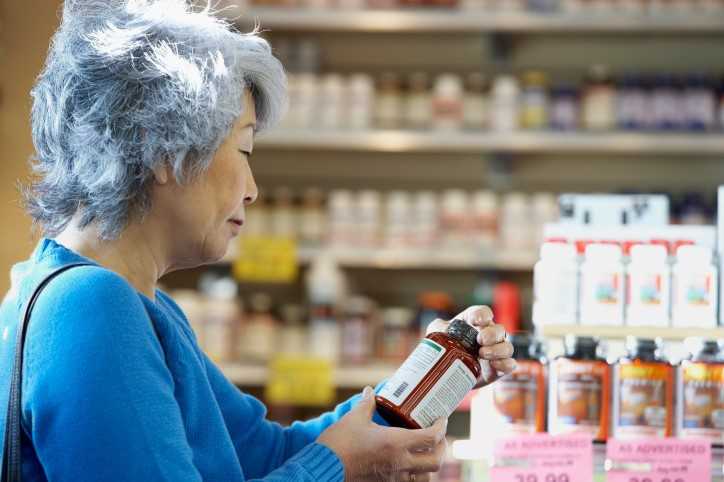 woman looking at dietary supplements